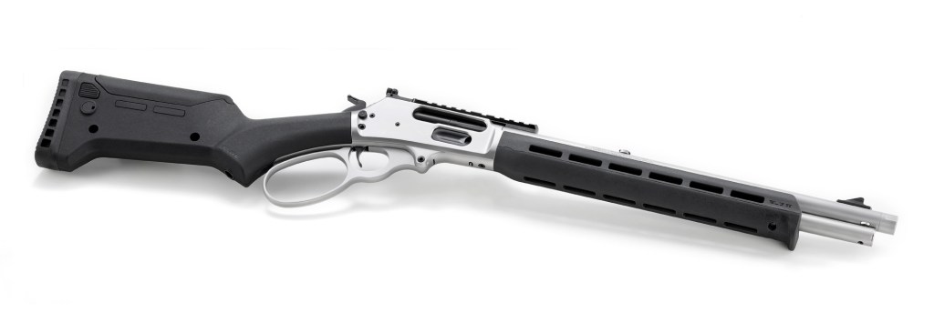 A detailed view of a silver and black firearm, featuring a modern stock and rail system.